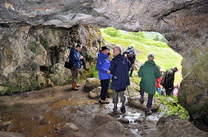 Delegates sheltering from the rain in Odin's Cave, Castleton during one of the Saturday walks.