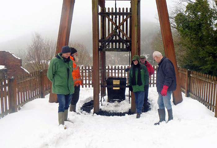 Members of the work party fitting the memorial plaque. (Steve Holding)